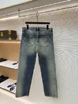 Dior distressed and ripped washed denim jeans with letter patch