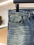 Dior distressed and ripped washed denim jeans with letter patch