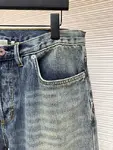 Dior distressed and ripped washed denim jeans with letter patch