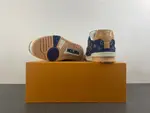 Louis Vuitton LV Trainer in deep royal blue, brown, and denim.