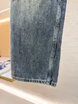 Dior distressed and ripped washed denim jeans with letter patch