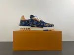 Louis Vuitton LV Trainer in deep royal blue, brown, and denim.