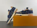 Louis Vuitton LV Trainer in deep royal blue, brown, and denim.