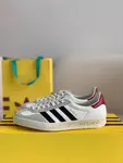 GU*I× Adidas sneakers